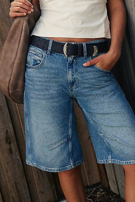 We The Free Double Cross Belt made from distressed leather with a bold, double-cross buckle design. This adjustable belt adds a rustic, boho-inspired touch to any outfit, perfect for pairing with jeans or dresses, Black