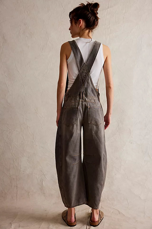 We The Free Good Luck Barrel Overalls with a relaxed, loose-fit design and wide-leg silhouette. These overalls feature adjustable straps and a soft, distressed denim fabric, offering a casual, boho-inspired look with a comfortable, laid-back feel, Archive Grey