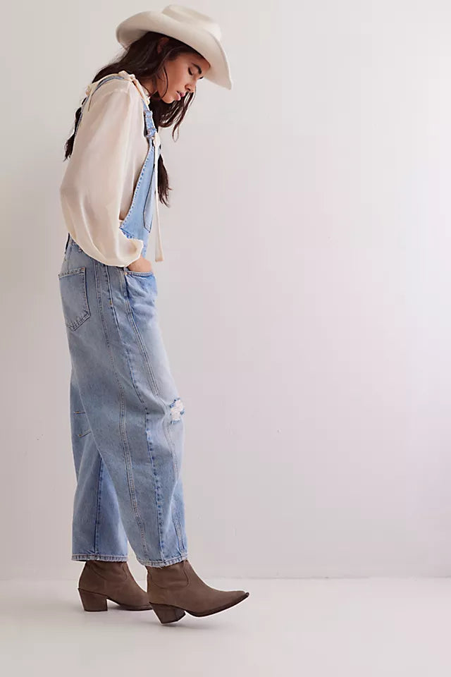 We The Free Good Luck Barrel Overalls with a relaxed, loose-fit design and wide-leg silhouette. These overalls feature adjustable straps and a soft, distressed denim fabric, offering a casual, boho-inspired look with a comfortable, laid-back feel, Going Steady