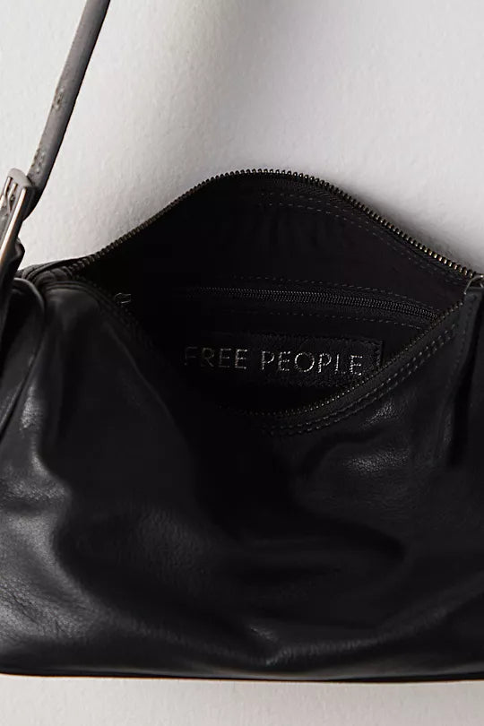 Free People Arm Candy Bag in luxe leather with a thick adjustable strap, rivet detailing, and a zip-top closure, Black