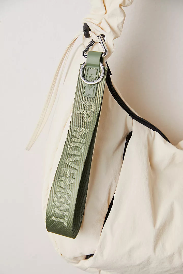 "Free People There It Is Keychain – A sporty and versatile keychain with the FP Movement logo at the center, Washed Sage